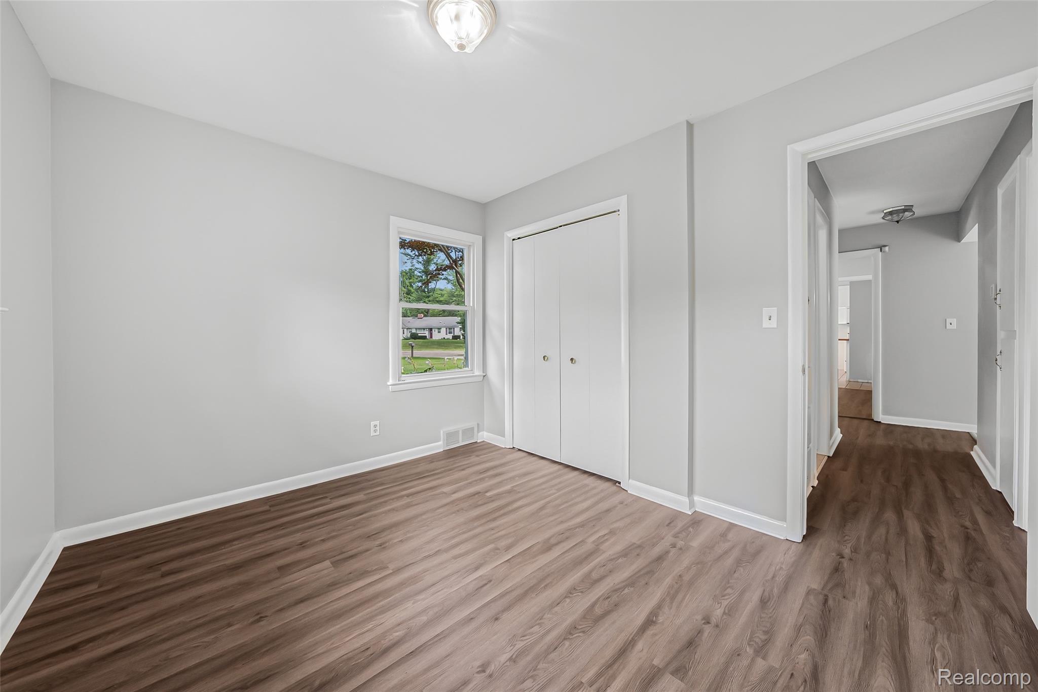2329 Rutherford Road Bloomfield Hills, MI 48302 - Photo 13 of 46 Wood-finish flooring, light gray wall paint, and white trim throughout