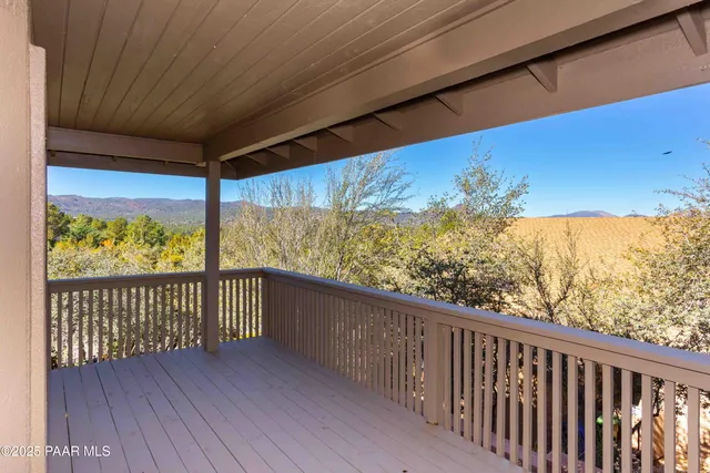 a view of a balcony with wooden fence