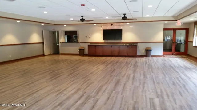 a view of a hall with wooden floor