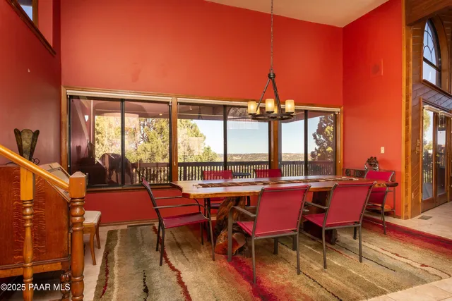 a view of a dining room with furniture and chandelier