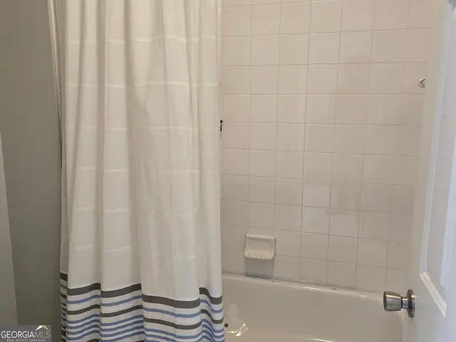 a bathroom with a shower curtain and a curtain