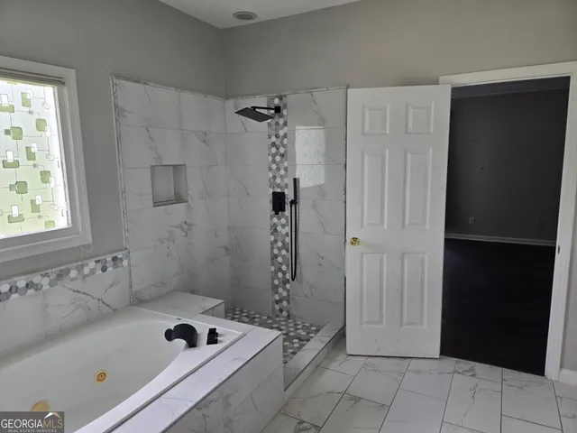 a bathroom with a bathtub and a shower