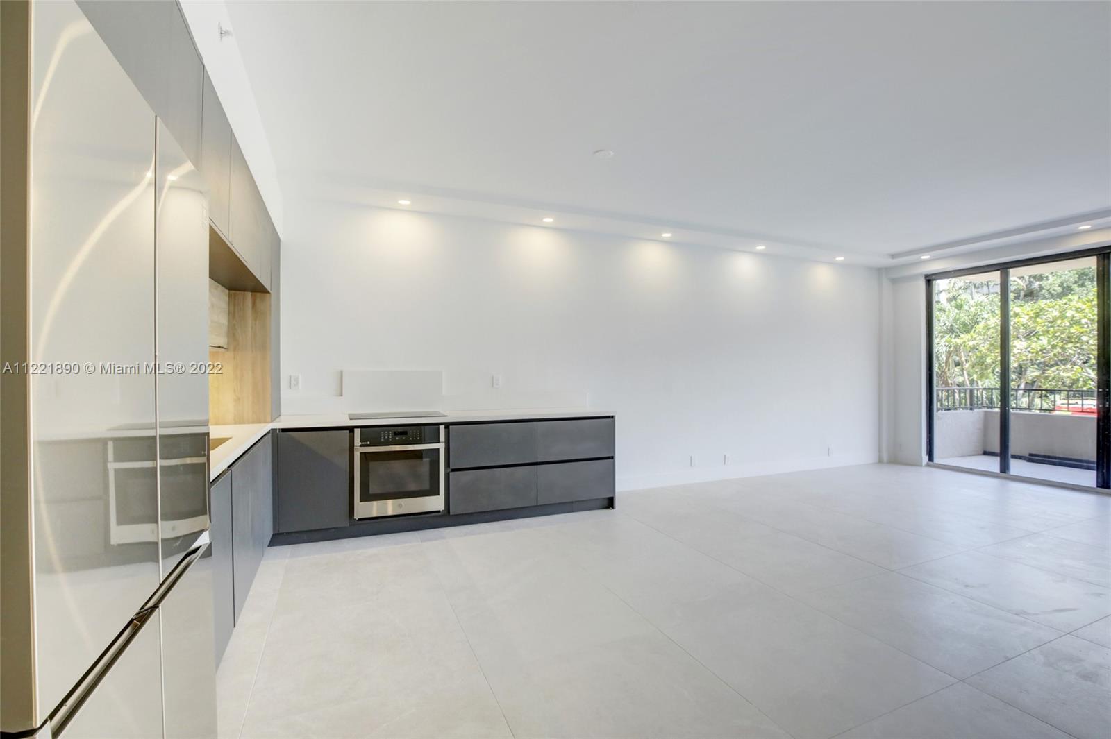 151 Crandon Boulevard, Unit 220 Key Biscayne, FL 33149 - Photo 2 of 16 a view of an empty room with furniture and windows