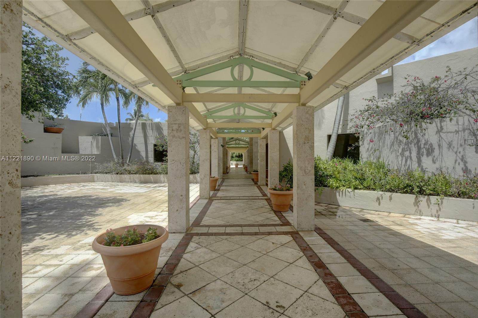 151 Crandon Boulevard, Unit 220 Key Biscayne, FL 33149 - Photo 10 of 16 a view of a porch with furniture and a yard