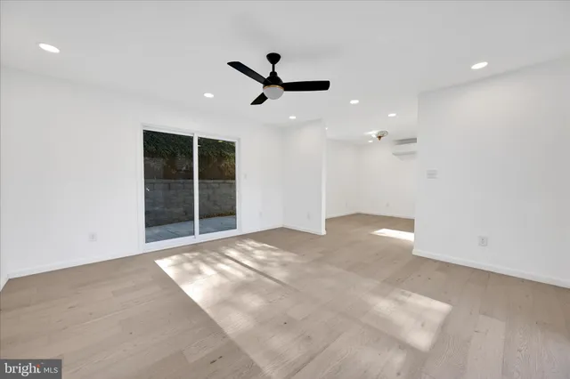 a view of an empty room with a ceiling fan