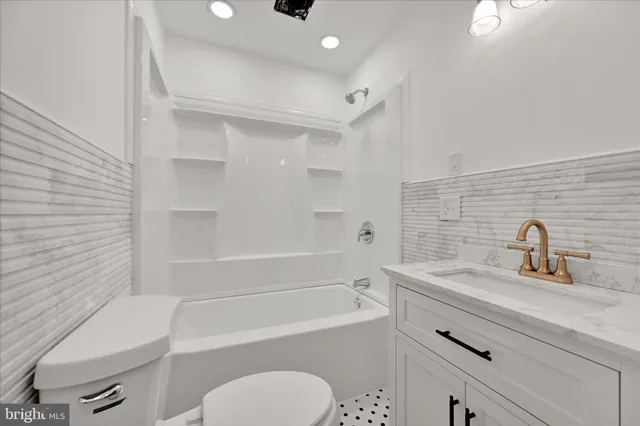 a bathroom with a sink a toilet and bathtub