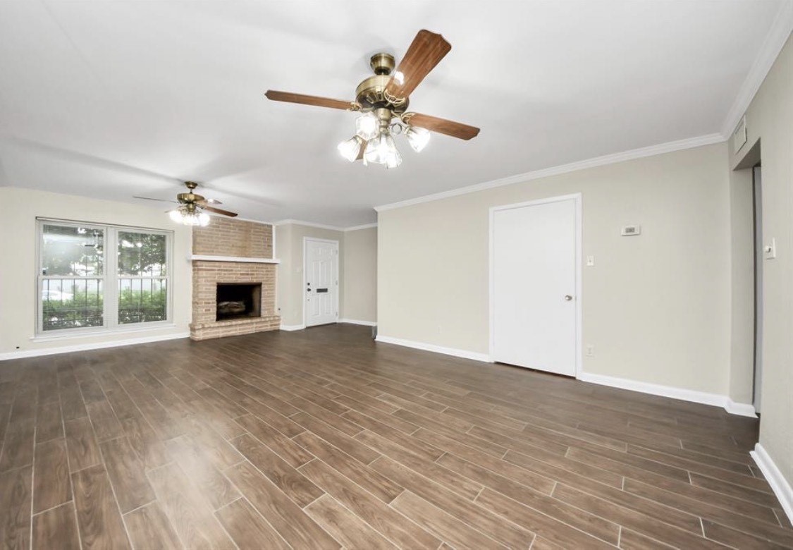 8234 Fondren Road, Unit 8234 Houston, TX 77074 - Photo 4 of 10 an empty room with wooden floor ceiling fan and windows