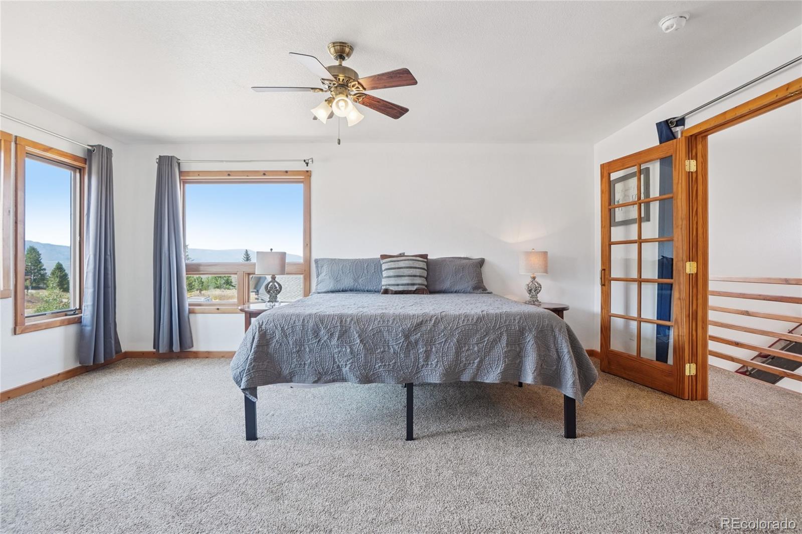 108 Hummingbird Way Granby, CO 80446 - Photo 19 of 46 a spacious bedroom with a bed and a window