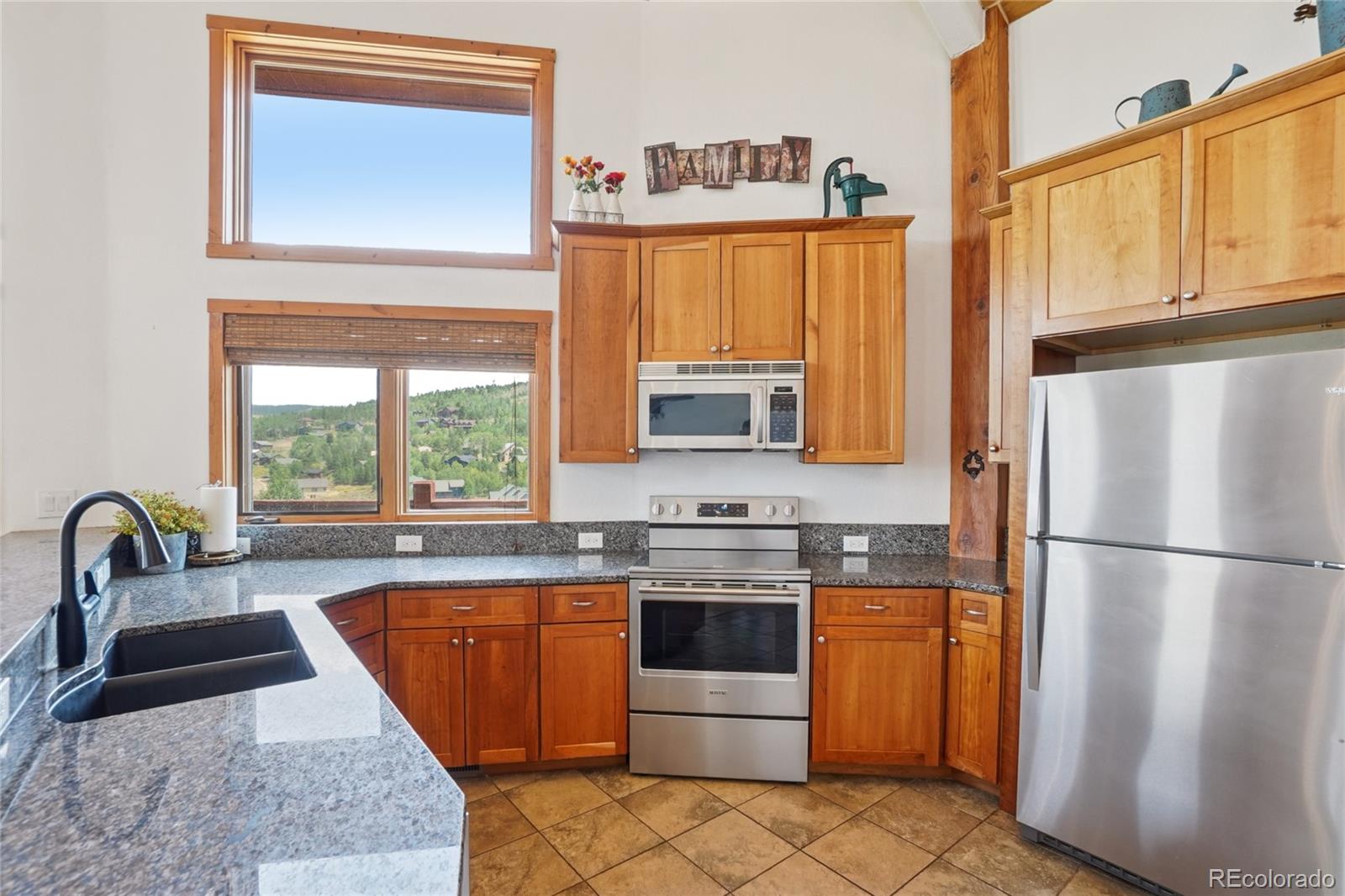 108 Hummingbird Way Granby, CO 80446 - Photo 9 of 46 a kitchen with stainless steel appliances granite countertop a refrigerator a stove a sink and a microwave