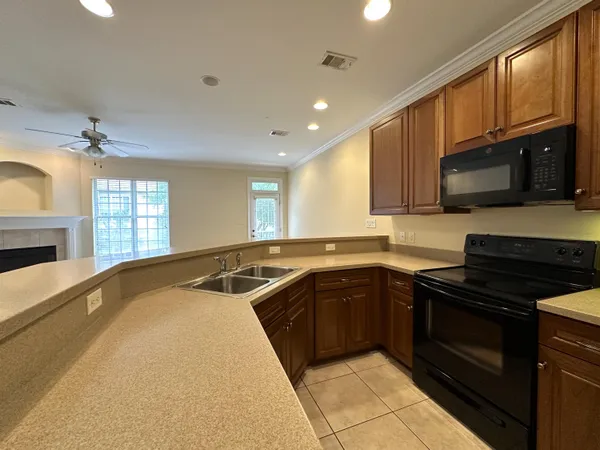 a kitchen with stainless steel appliances granite countertop a sink and stove top oven