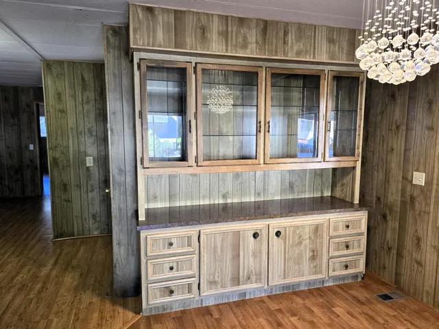 a view of walk in closet with plants and cabinets