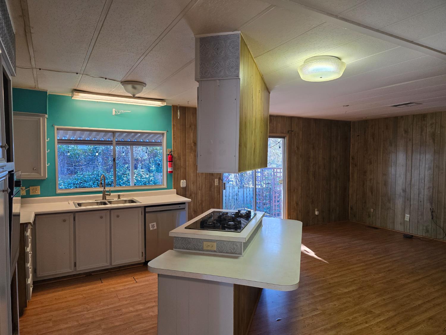 30 Candy Lane Grass Valley, CA 95945 - Photo 9 of 48 a kitchen with stainless steel appliances granite countertop a sink a stove and a wooden floor