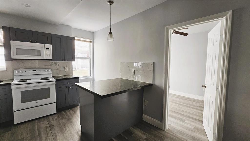 a kitchen with a sink stove and refrigerator