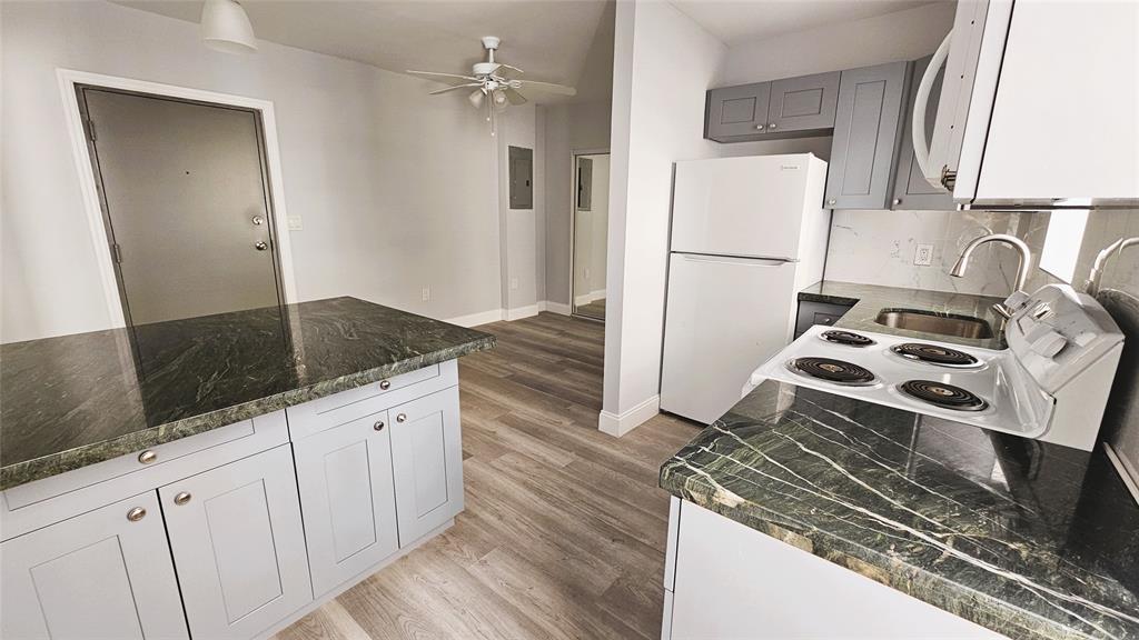 1142 Southwest 4th Street, Unit 3 Miami, FL 33130 - Photo 11 of 17 a kitchen with granite countertop a refrigerator stove and sink