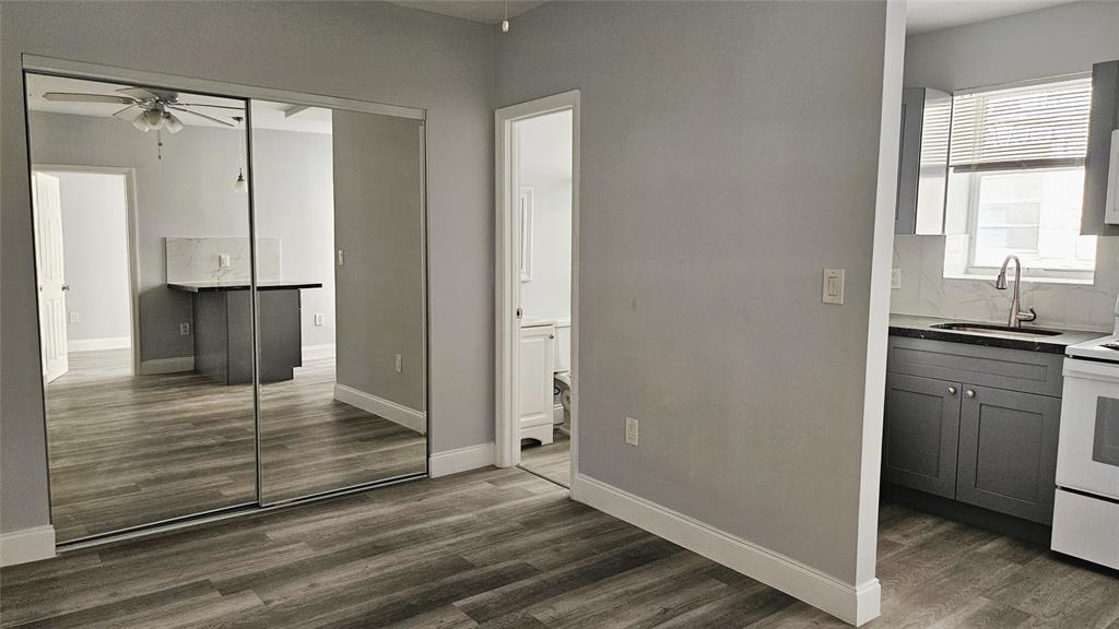 1142 Southwest 4th Street, Unit 3 Miami, FL 33130 - Photo 12 of 17 a view of kitchen with wooden floor and electronic appliances