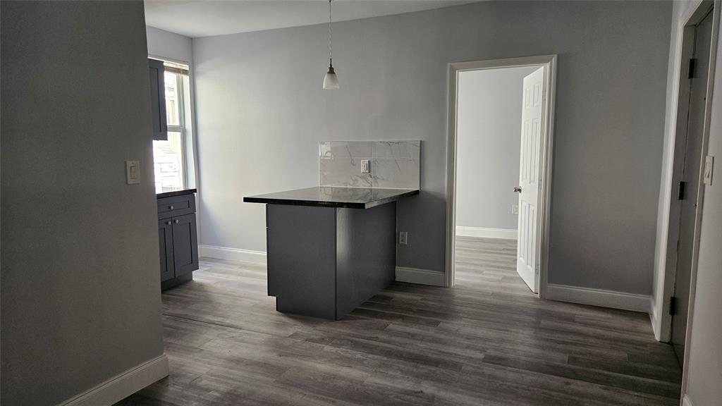 1142 Southwest 4th Street, Unit 3 Miami, FL 33130 - Photo 14 of 17 an empty room with wooden floor closet and windows