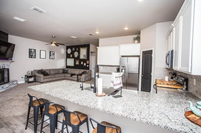 a kitchen with a refrigerator and a dining table