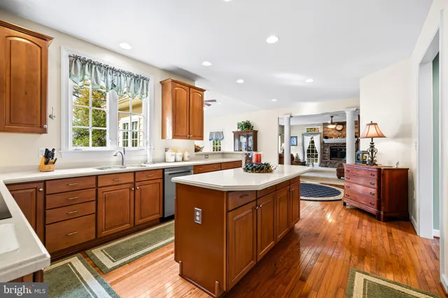 a view of a dining room with furniture a rug and wooden floor