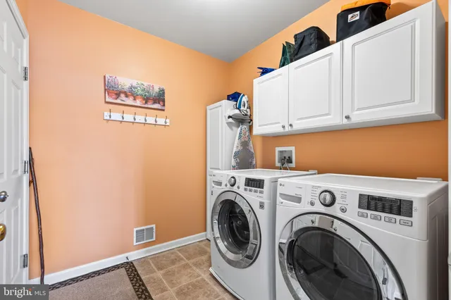 a spacious bedroom with a bed and a chandelier