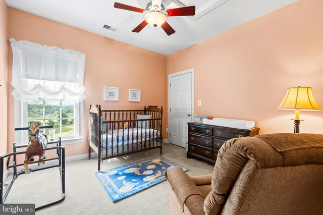 a bedroom with a bed and a potted plant