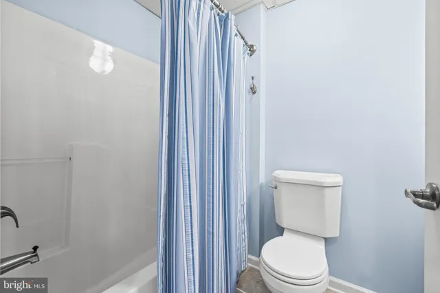 a view of a house with a big yard and large trees