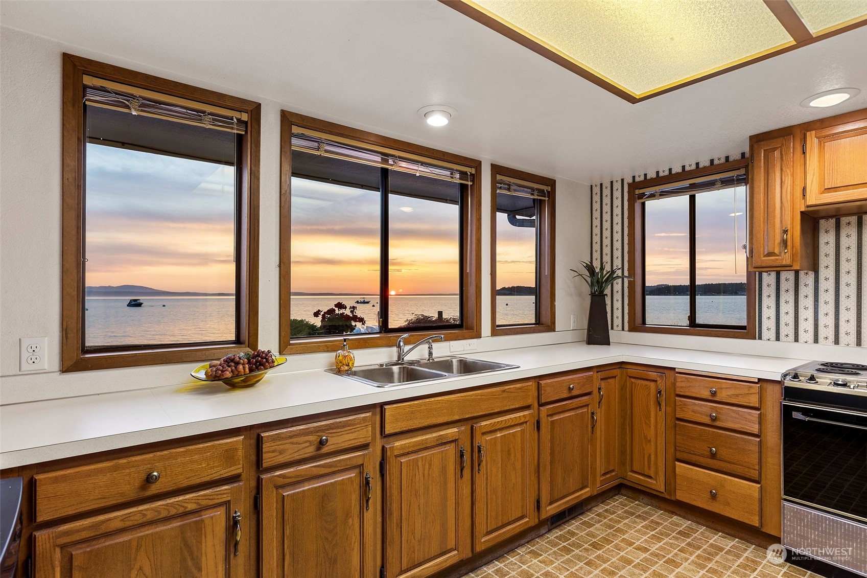 6288 Barr Beach Road Freeland, WA 98249 - Photo 19 of 40 a kitchen with a sink stove and cabinets