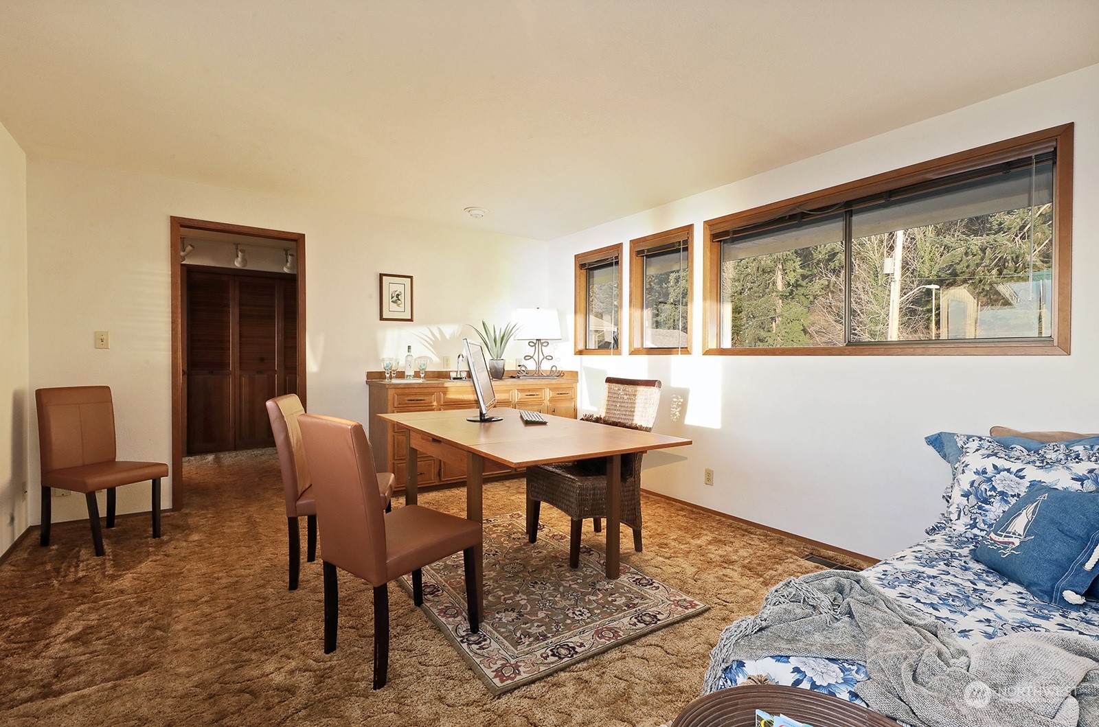 6288 Barr Beach Road Freeland, WA 98249 - Photo 21 of 40 a bedroom with a table chairs and a bed