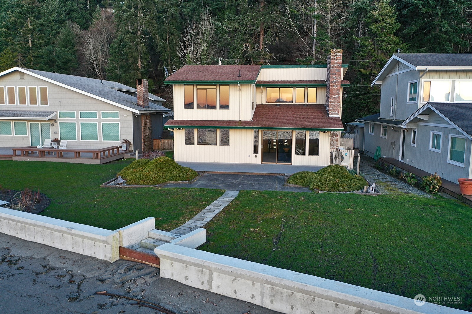 6288 Barr Beach Road Freeland, WA 98249 - Photo 3 of 40 a front view of a house with a garden and trees