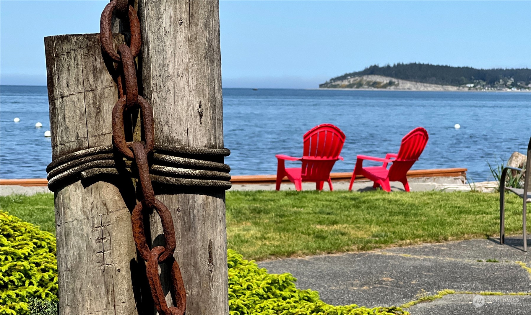6288 Barr Beach Road Freeland, WA 98249 - Photo 7 of 40 a view of a wooden bench in front of a yard