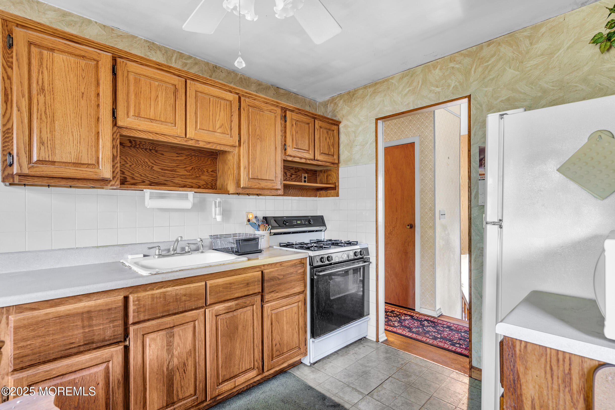 30 Russell Street Toms River, NJ 08753 - Photo 7 of 27 a kitchen with stainless steel appliances granite countertop a refrigerator stove and sink