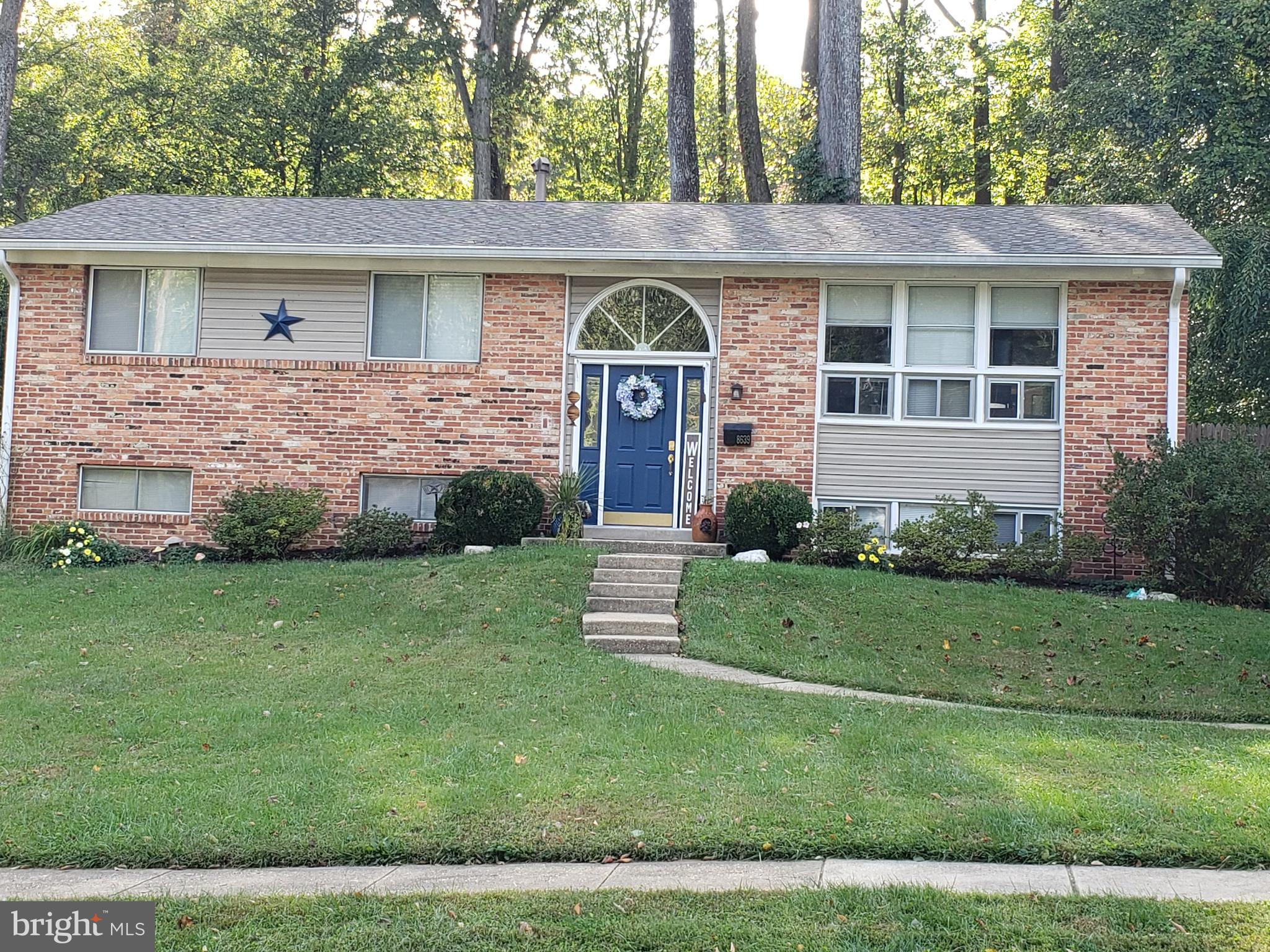 8639 Victoria Road Springfield, VA 22151 - Photo 1 of 17 a front view of a house with a garden