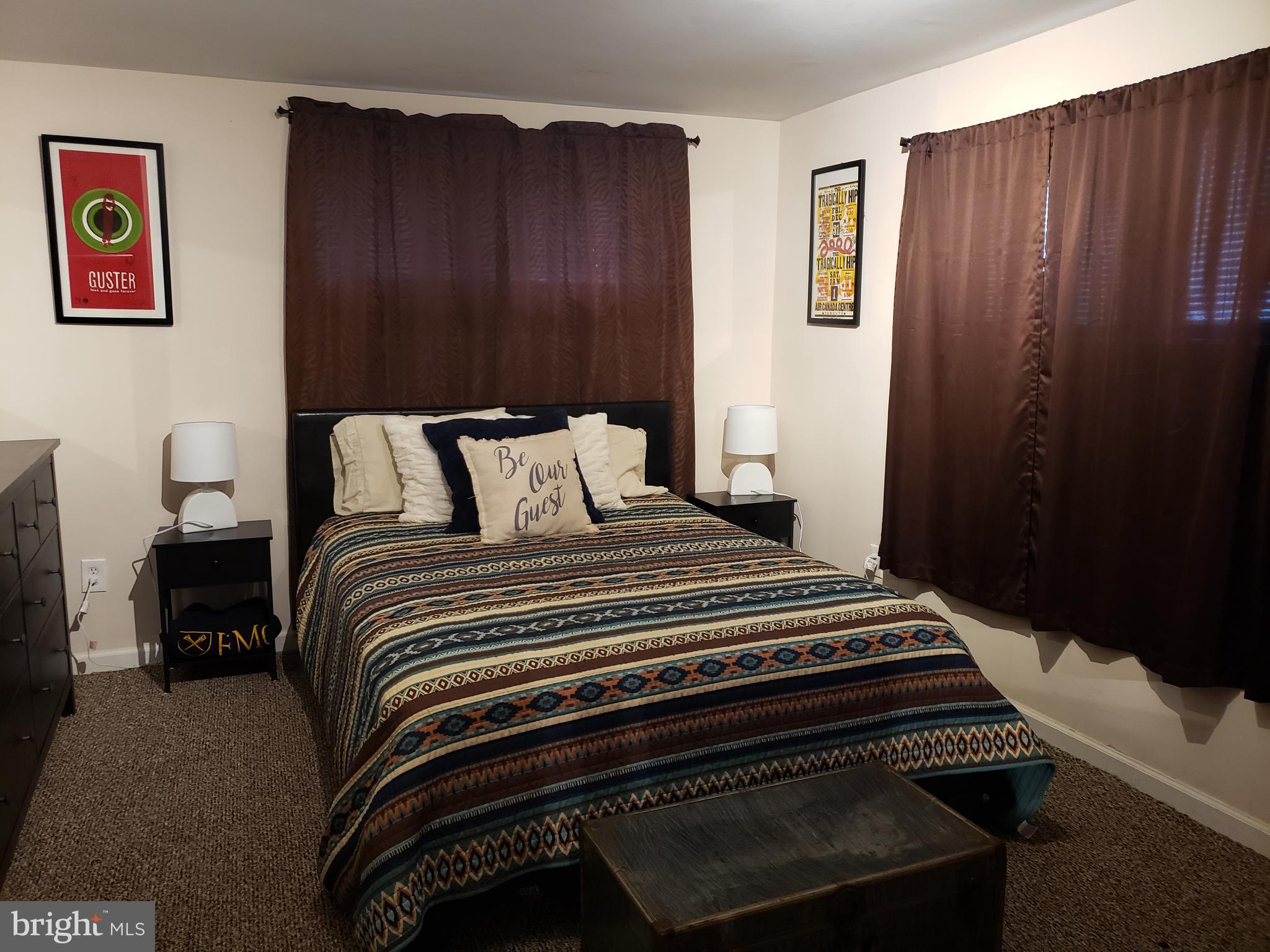8639 Victoria Road Springfield, VA 22151 - Photo 14 of 17 a bedroom with a bed and wooden floor