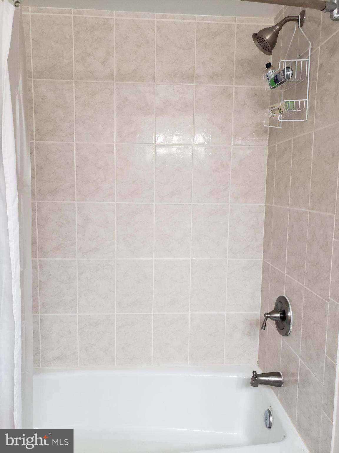 8639 Victoria Road Springfield, VA 22151 - Photo 16 of 17 a bathroom with a shower and a bathtub