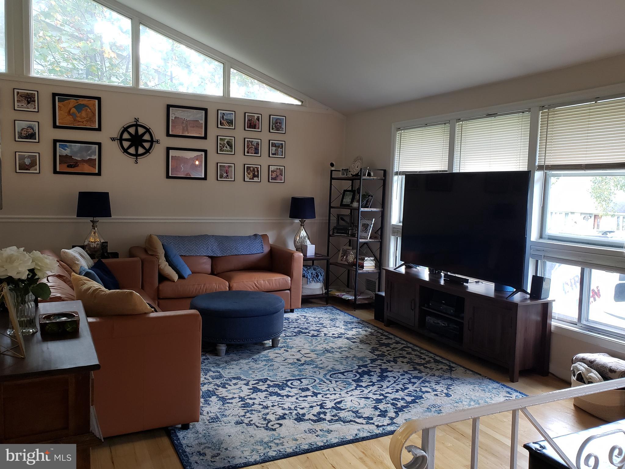 8639 Victoria Road Springfield, VA 22151 - Photo 3 of 17 a living room with furniture and a flat screen tv