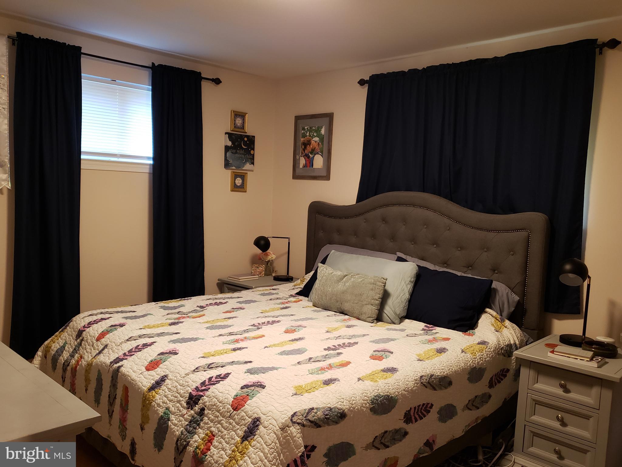 8639 Victoria Road Springfield, VA 22151 - Photo 8 of 17 a bedroom with a bed and wooden floor
