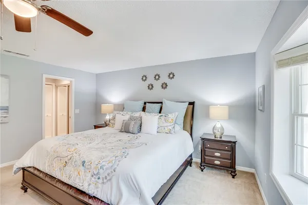 a bedroom with a bed and a night stand