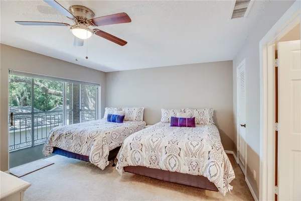a bedroom with two beds and a chandelier