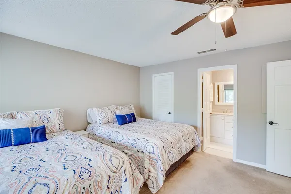 a bedroom with a bed and ceiling fan