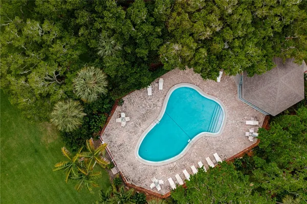 an aerial view of a swimming pool and garden