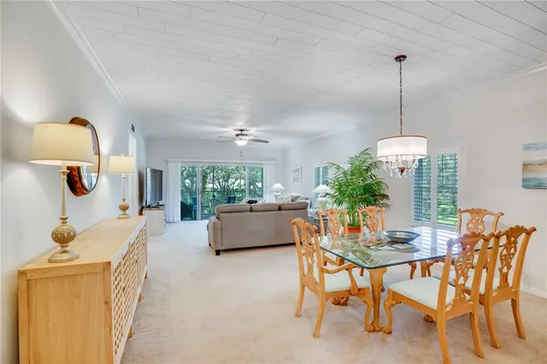 a dining room with furniture and a chandelier