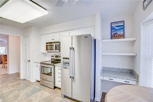 a kitchen with stainless steel appliances a refrigerator and a stove top oven
