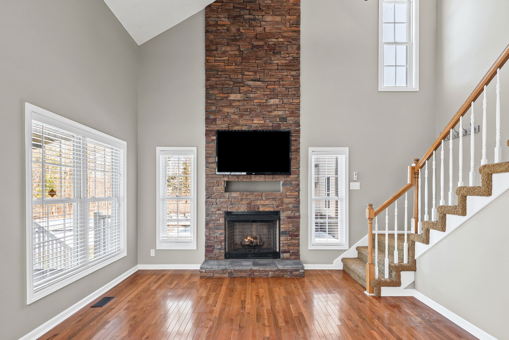 2875 Jarrell Ridge Road Clarksville, TN 37043 - Photo 15 of 73 a view of an empty room with wooden floor fireplace and a window