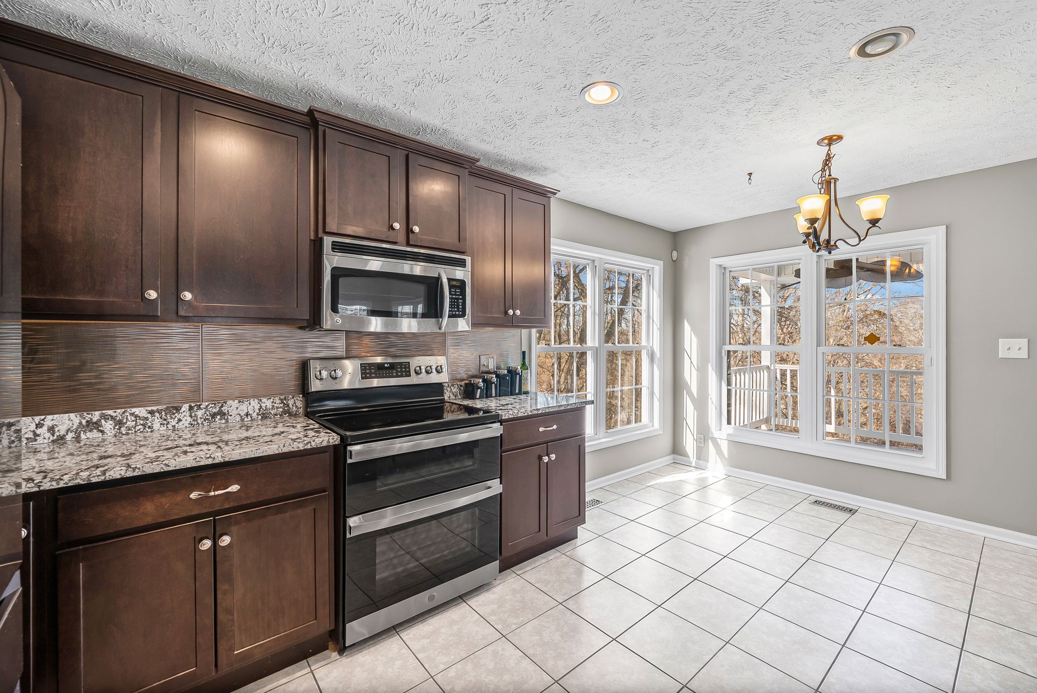 2875 Jarrell Ridge Road Clarksville, TN 37043 - Photo 21 of 73 a kitchen with stainless steel appliances granite countertop a stove a sink and a microwave