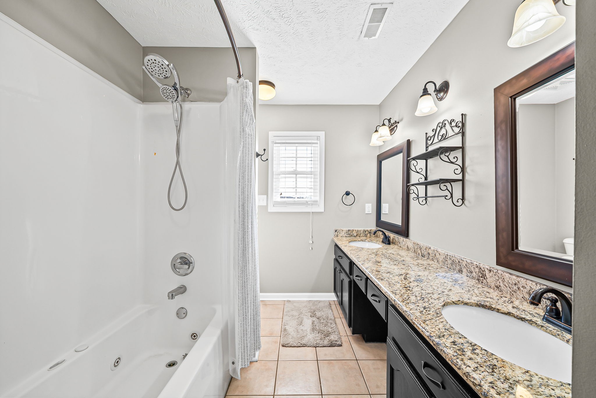 2875 Jarrell Ridge Road Clarksville, TN 37043 - Photo 36 of 73 a spacious bathroom with a granite countertop sink mirror and shower
