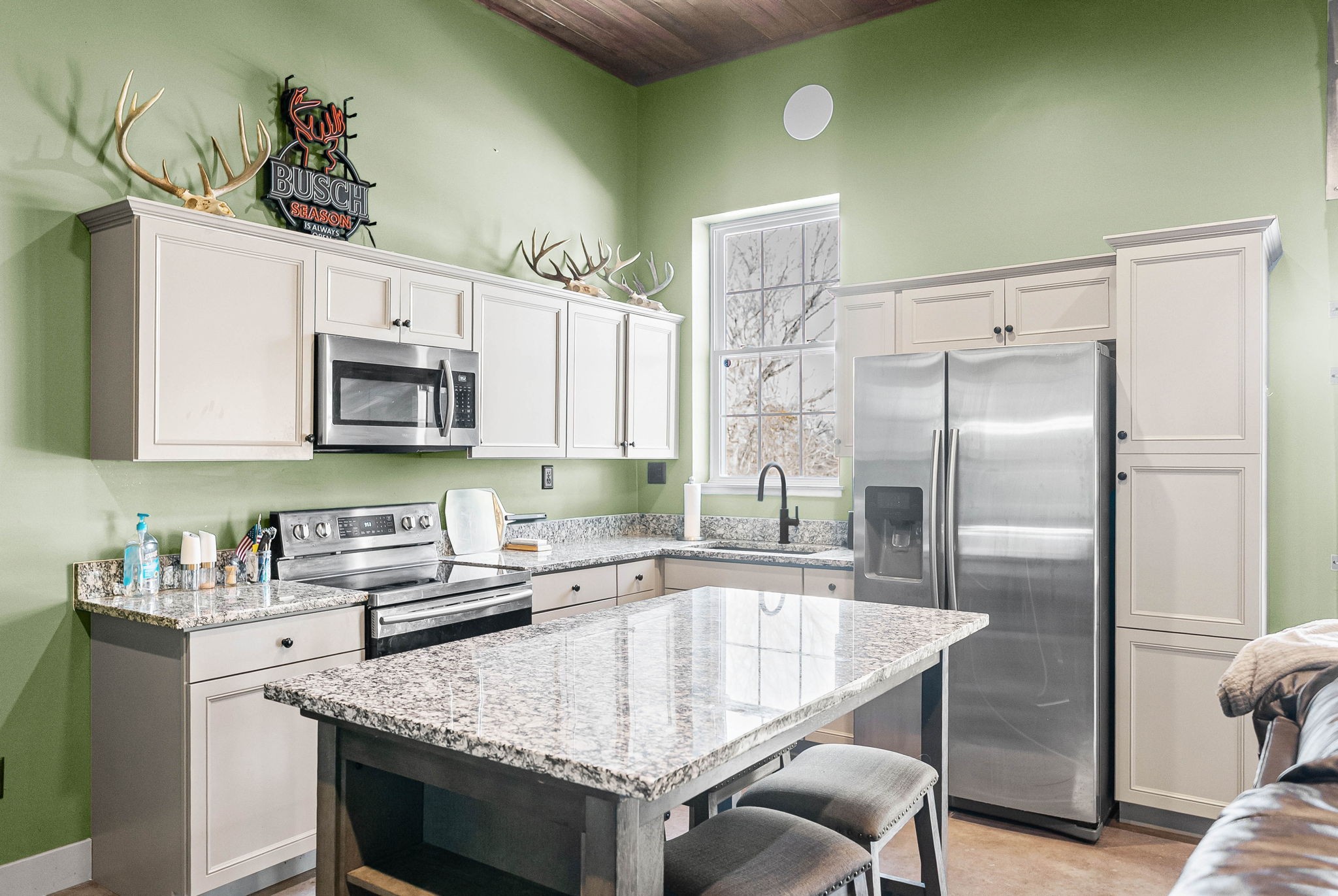 2875 Jarrell Ridge Road Clarksville, TN 37043 - Photo 61 of 73 a kitchen with stainless steel appliances granite countertop a table chairs sink refrigerator and microwave