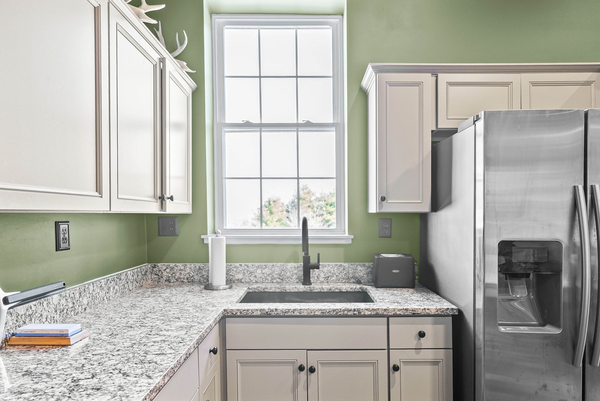 2875 Jarrell Ridge Road Clarksville, TN 37043 - Photo 62 of 73 a kitchen with a granite countertop sink a refrigerator and a granite counter tops