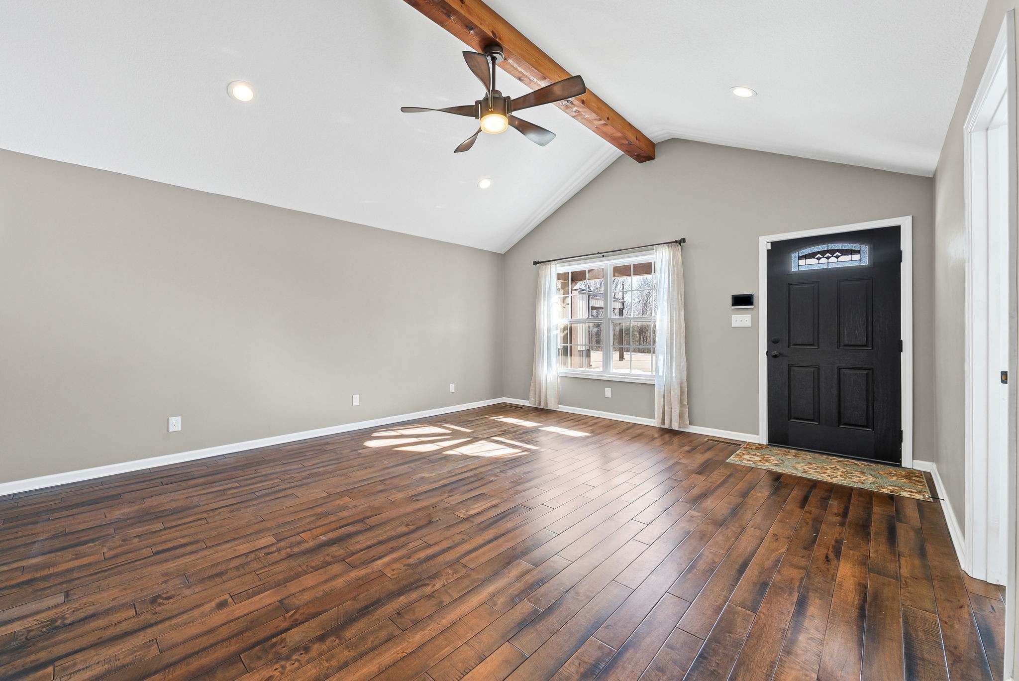 2875 Jarrell Ridge Road Clarksville, TN 37043 - Photo 10 of 73 an empty room with wooden floor ceiling fan and windows