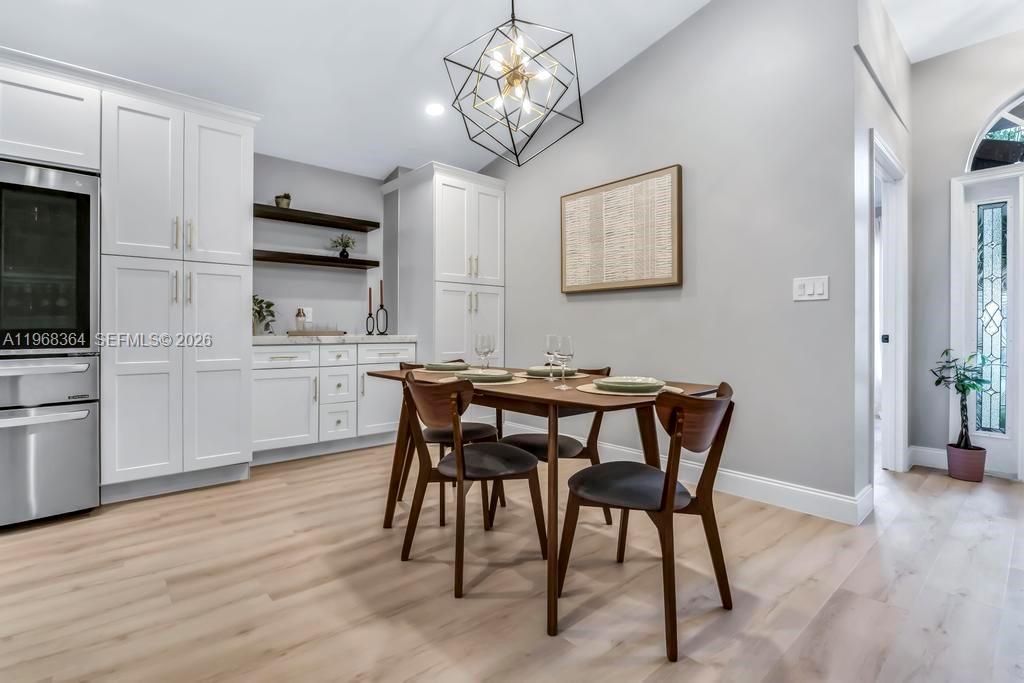 2972 Southwest 174th Avenue Miramar, FL 33029 - Photo 11 of 55 a view of a dining room with furniture and wooden floor