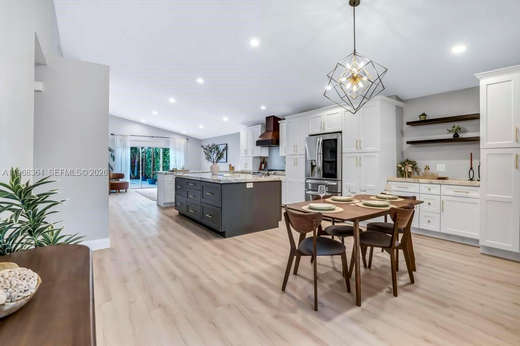 2972 Southwest 174th Avenue Miramar, FL 33029 - Photo 13 of 55 a view of a dining room with furniture wooden floor and chandelier
