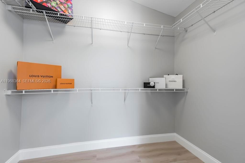 2972 Southwest 174th Avenue Miramar, FL 33029 - Photo 19 of 55 a view of walk in closet with clothes and shoes